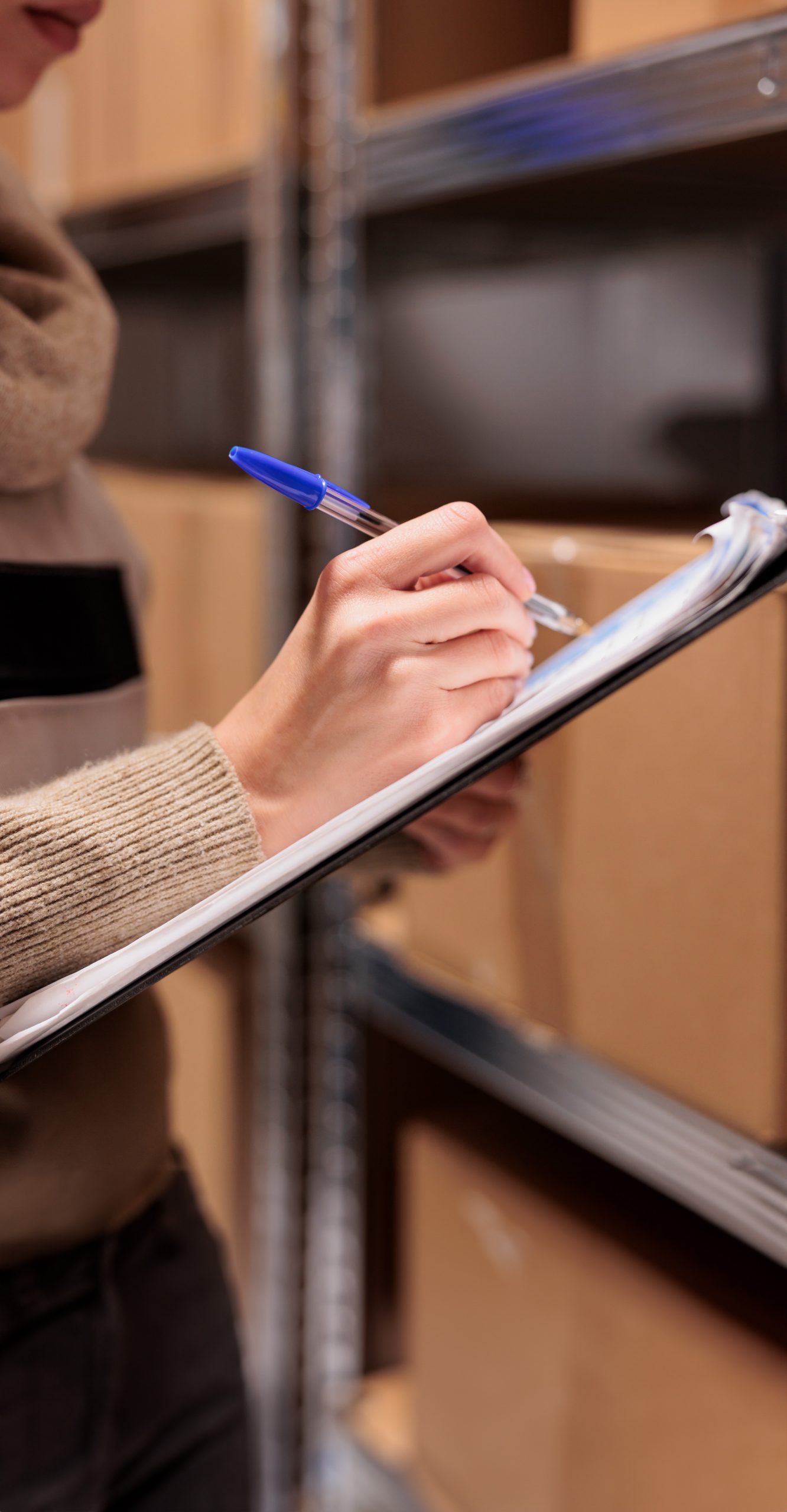 post-office-warehouse-employee-searching-parcel-checking-postal-form-young-caucasian-woman-supervising-cardboard-boxes-mail-sorting-center-writing-clipboard-close-up-1-scaled Expand your Amazon Business to Europe